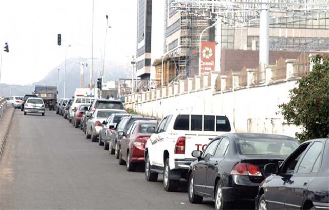 Motorists queue for fuel at a filling station in Abuja